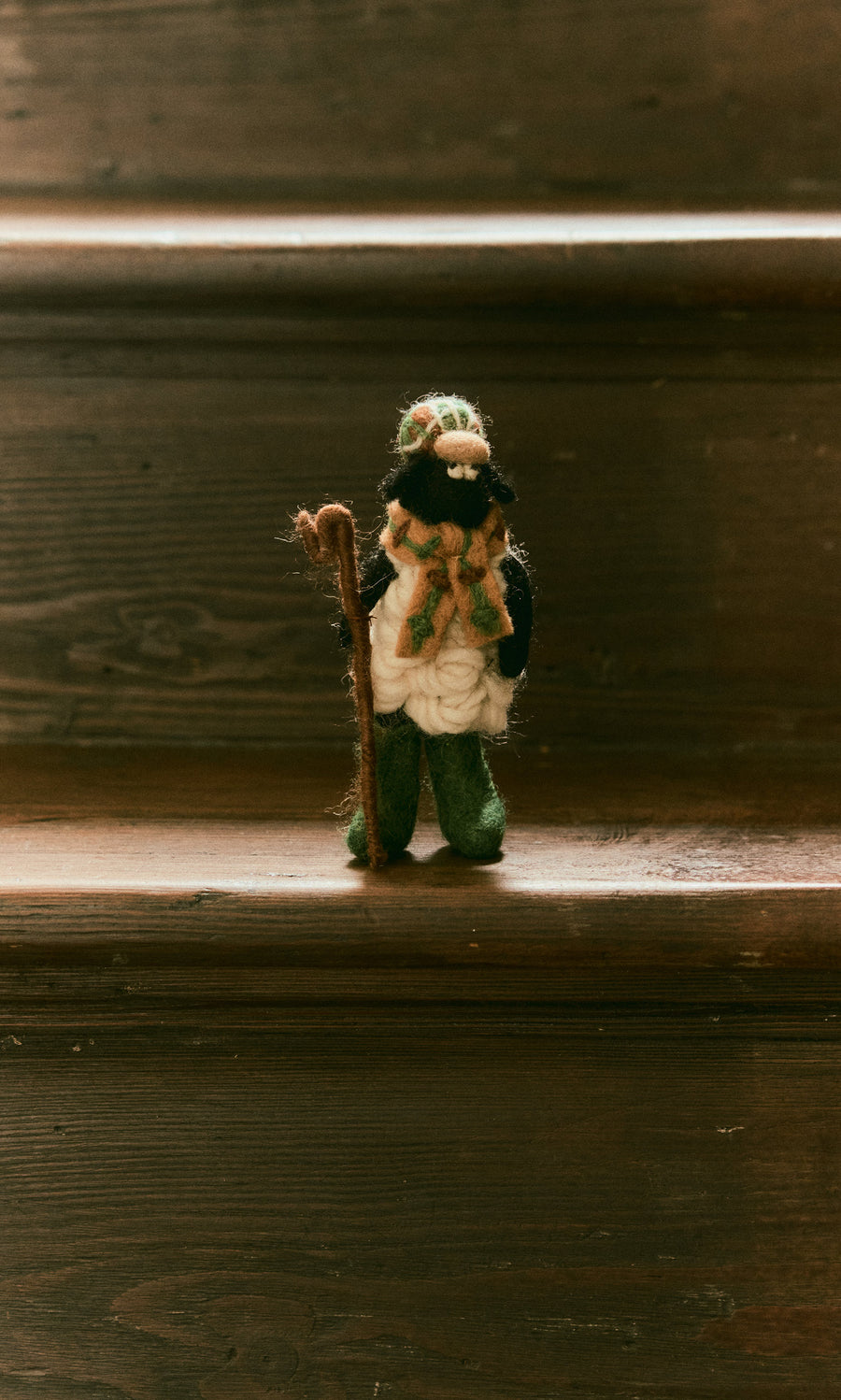Plümo  Handcrafted in Nepal, this Flat Cap Sheep felted wool figurine wears a flat cap and scarf while holding a wooden crook.