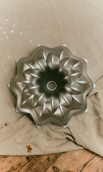 Plümo  Silver Star Cake Form, a star-shaped cast aluminium Bundt pan with a fluted design.