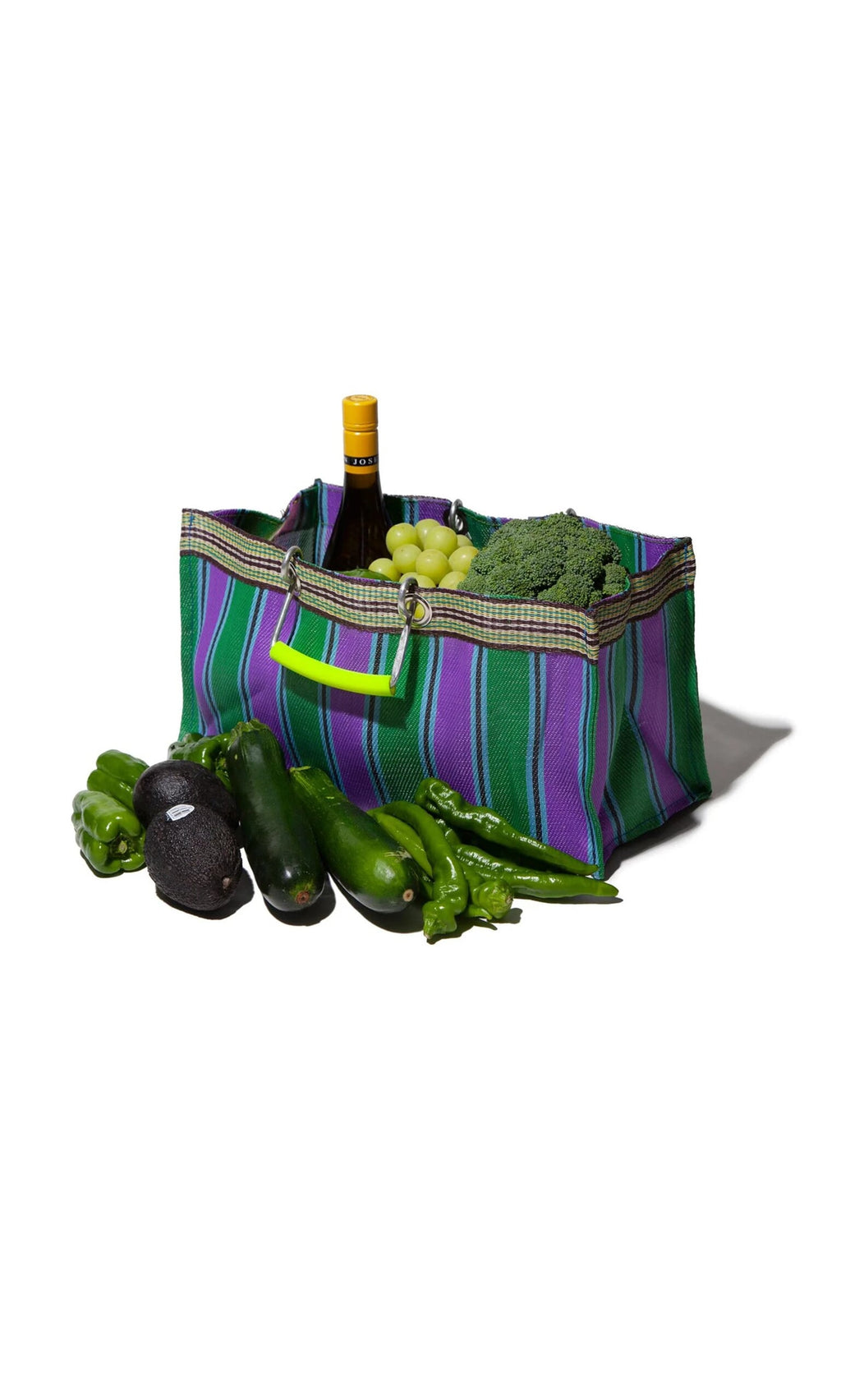 Plümo- The Recycled Stripe Shopper, in green and purple stripes, holds wine, grapes, broccoli, and green veggies in front.