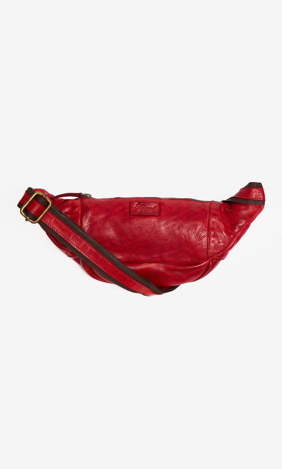 Plümo- Redwick Bag: red leather crossbody with British design, brown adjustable strap, and gold buckle on white background.