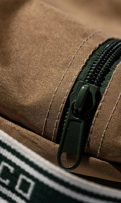 Plümo- Close-up of the Rubberised Shoe Case with green zipper, brown fabric, and white-green stripes—perfect for travel storage.