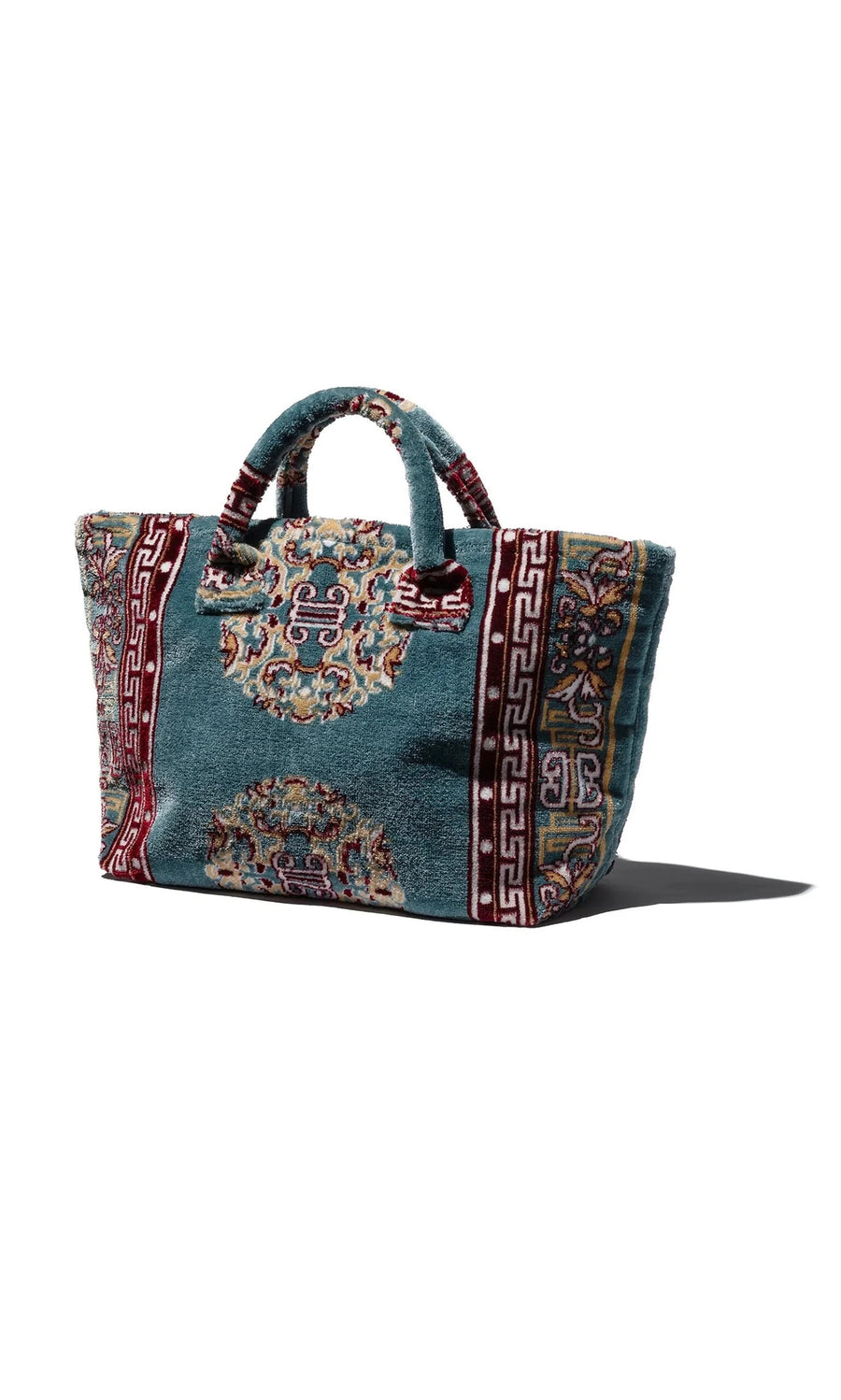 Plümo- The Rug Bag - Persian Blue features ornate blue, red, and gold patterns with short handles and textured fabric.