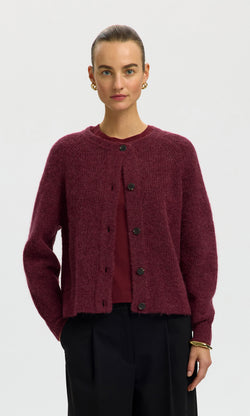 Plümo  Woman in the Caen Cardigan - Jam, matching top, black pants, gold earrings and bracelet against white background.