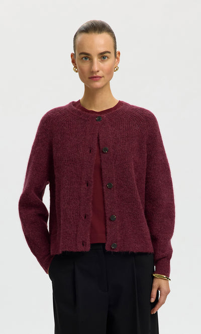 Plümo  Woman in the Caen Cardigan - Jam, matching top, black pants, gold earrings and bracelet against white background.
