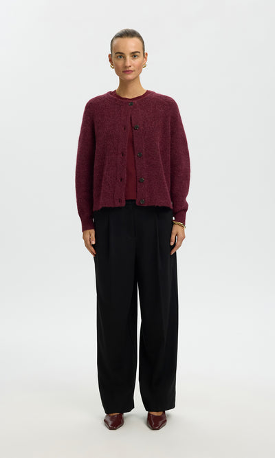 Plümo  Person wearing a Caen Cardigan - Jam, matching top and shoes, and black wide-leg pants on a white background.