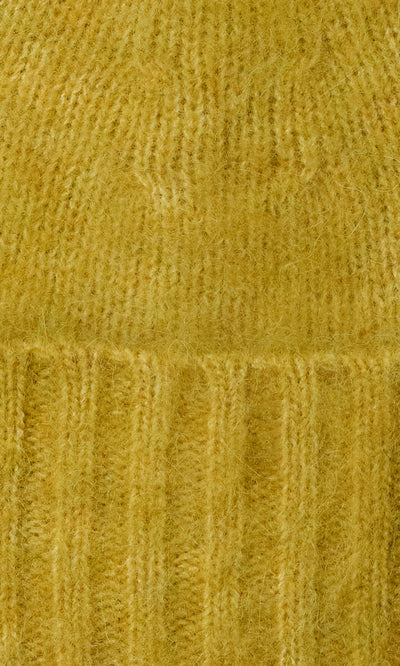 Plümo  Close-up of Avo Wool Beanie in yellow, featuring fuzzy knit with vertical and horizontal ribbed patterns and cuff.