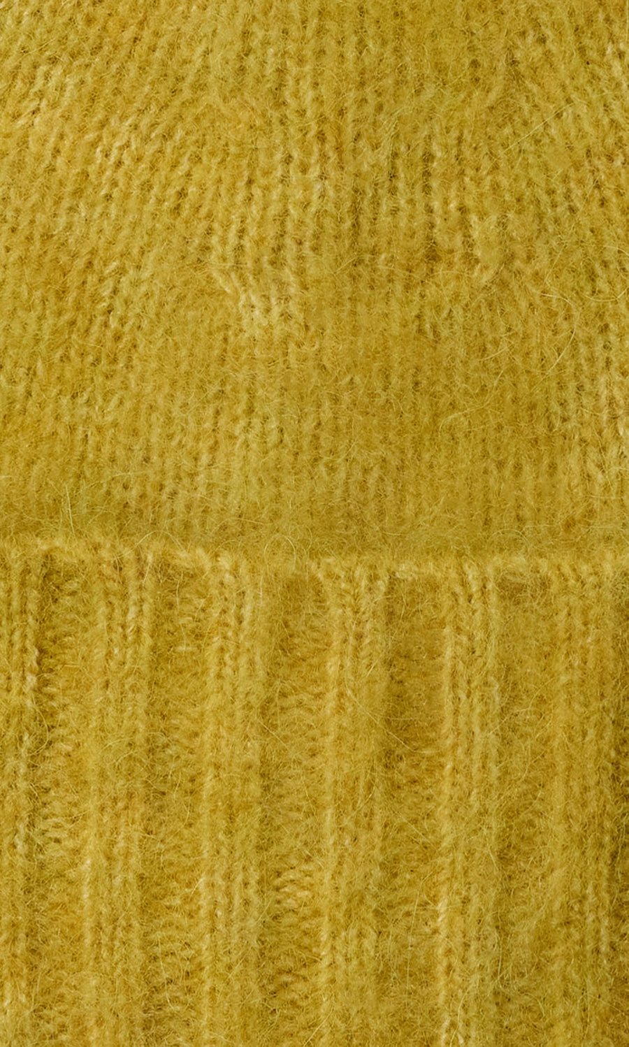 Plümo  Close-up of Avo Wool Beanie in yellow, featuring fuzzy knit with vertical and horizontal ribbed patterns and cuff.