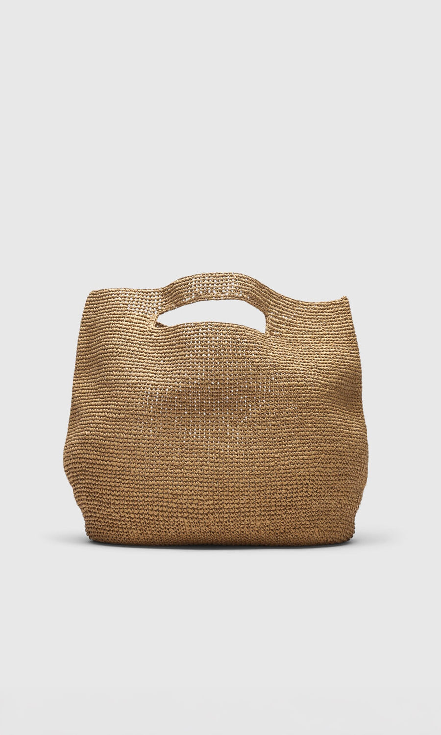 Plümo- Tara Straw Bag with short cutout handles, featuring timeless Danish design on a plain light background.