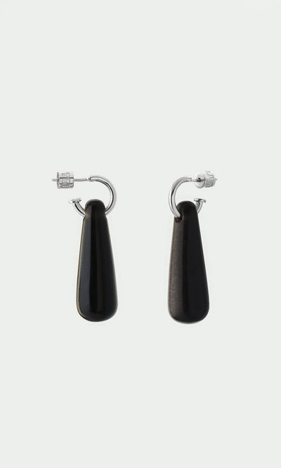 Plümo- Hera Earrings: Silver huggie hoops with long black teardrop pendants—protective healing jewelry.