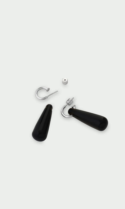 Plümo- Hera Earrings: silver huggie hoops with black teardrop pendants, a stylish choice for healing jewelry lovers, disassembled.