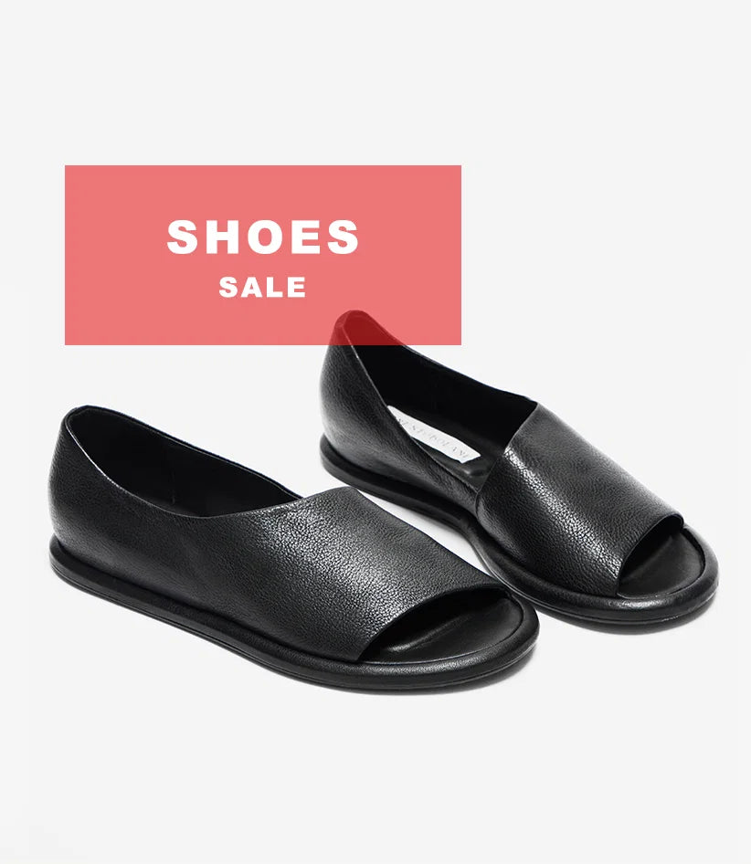 Plümo  Pair of black open-toe flat shoes on display; red banner above reads Shoes Sale in white text.
