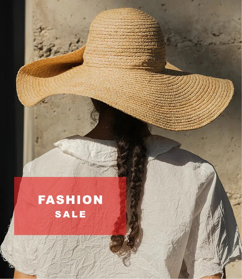 Plümo  Woman in a wide-brim straw hat and white blouse stands outdoors; FASHION SALE text appears in a red box.