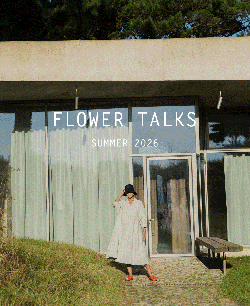 Plümo  Person in a light coat and hat stands outside a modern building with Flower Talks Summer 2026 text above.