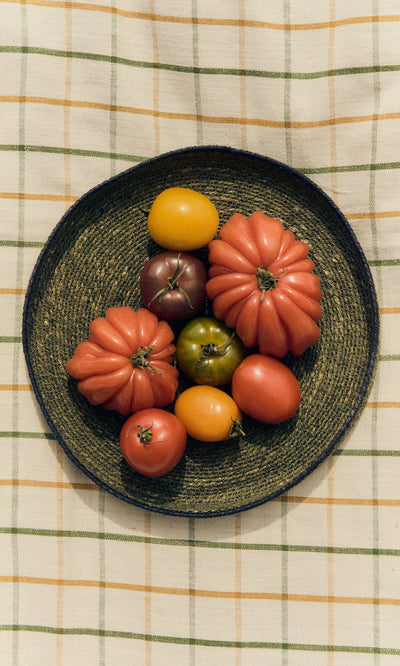 Plümo- A seagrass food cover on a checkered tablecloth brings rustic charm to your home decor.