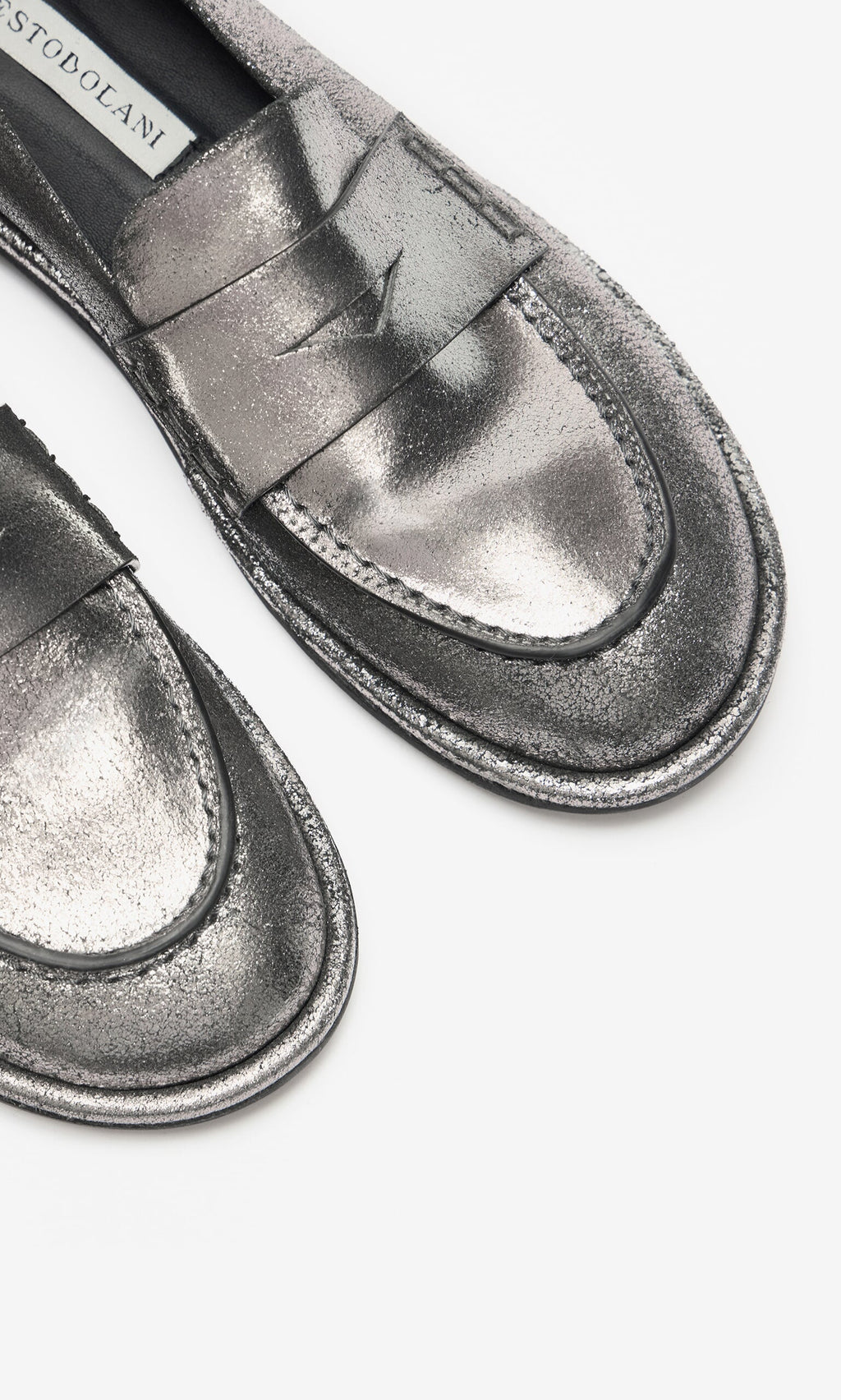 Plümo- Close-up of Silver Loafers with metallic leather, stitching detail, and detachable ankle straps on a white background.