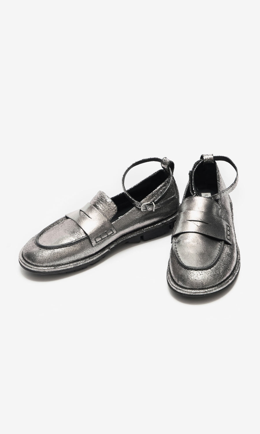 Plümo- Silver Loafers with detachable ankle straps, one upright and one leaning on a white background.