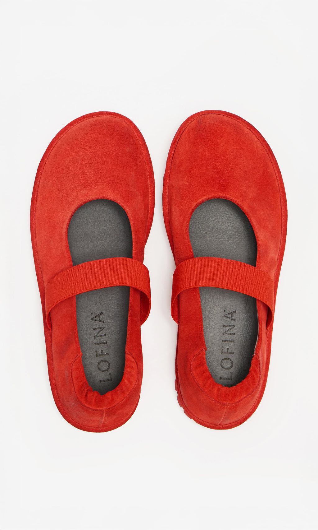 Plümo- Sola Red Flats: Scarlet suede Mary Jane shoes with elastic straps and black insoles on a white background.