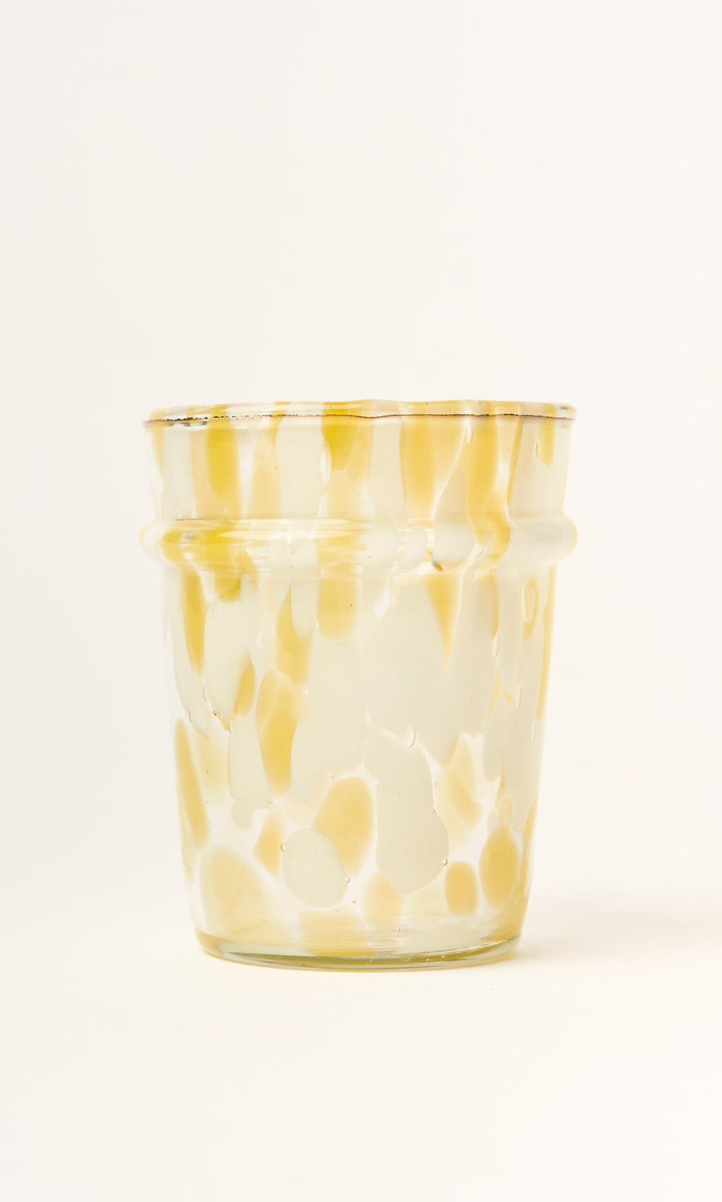 Plümo- The Speckled Drinking Glass - Yellow is handmade in Firozabad with yellow and cream speckles on clear glass.