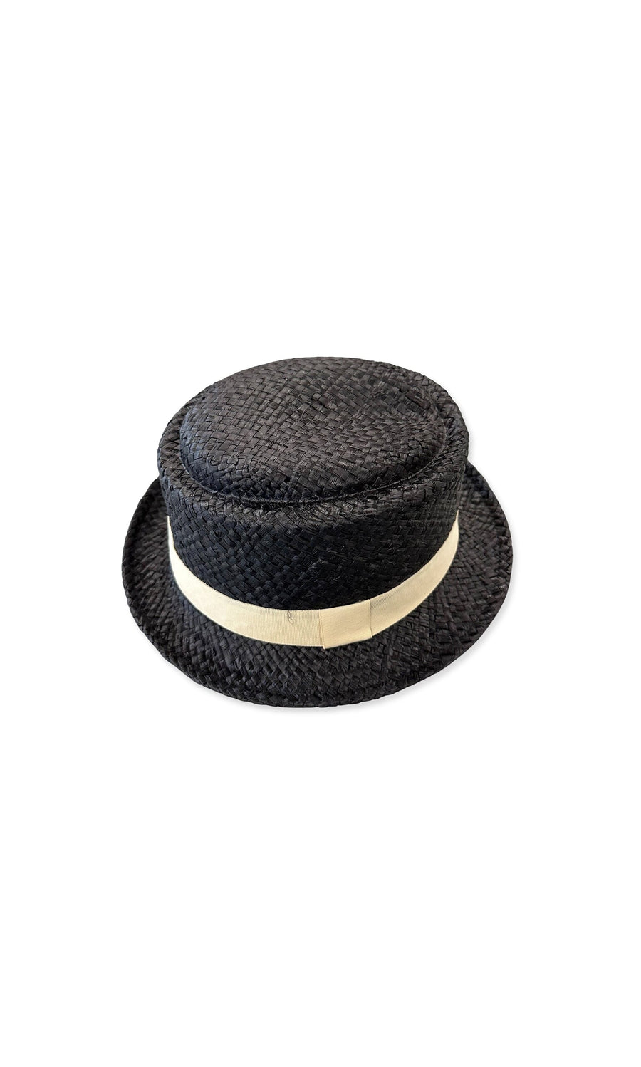 Plümo- The Pax Hat is a black straw hat with sun coverage, a flat crown, and a beige ribbon trim.