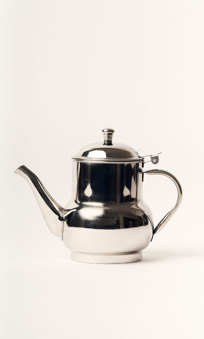 Plümo- The Steel Teapot features an industrial stainless steel finish and curved spout, shown on a plain white background.