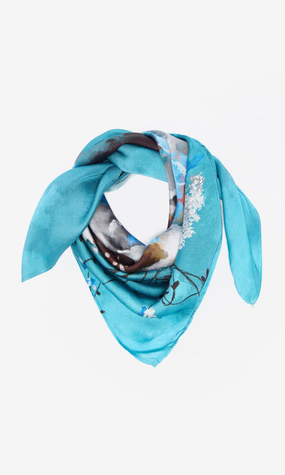 Plümo- An Ultramarine Necktie, shown folded in a triangle, features impressionistic florals on silk.