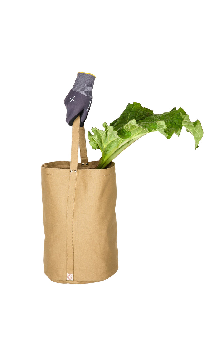 Plümo- A tan Canvas tool bag holds green vegetables and a gray gardening glove against a white background.