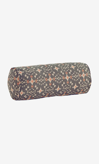 Plümo- Printed Bolster Cushion - Grey: A cylindrical cotton cushion with a dark geometric pattern in orange and white.