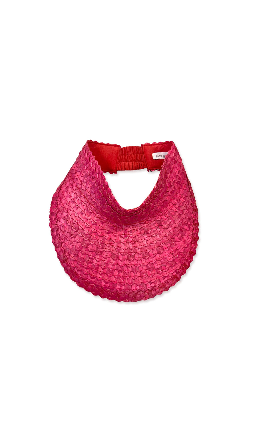 Plümo- The Maris Sun Visor - Raspberry is a handwoven, wide-brimmed pink palm leaf visor with a red elastic back band.