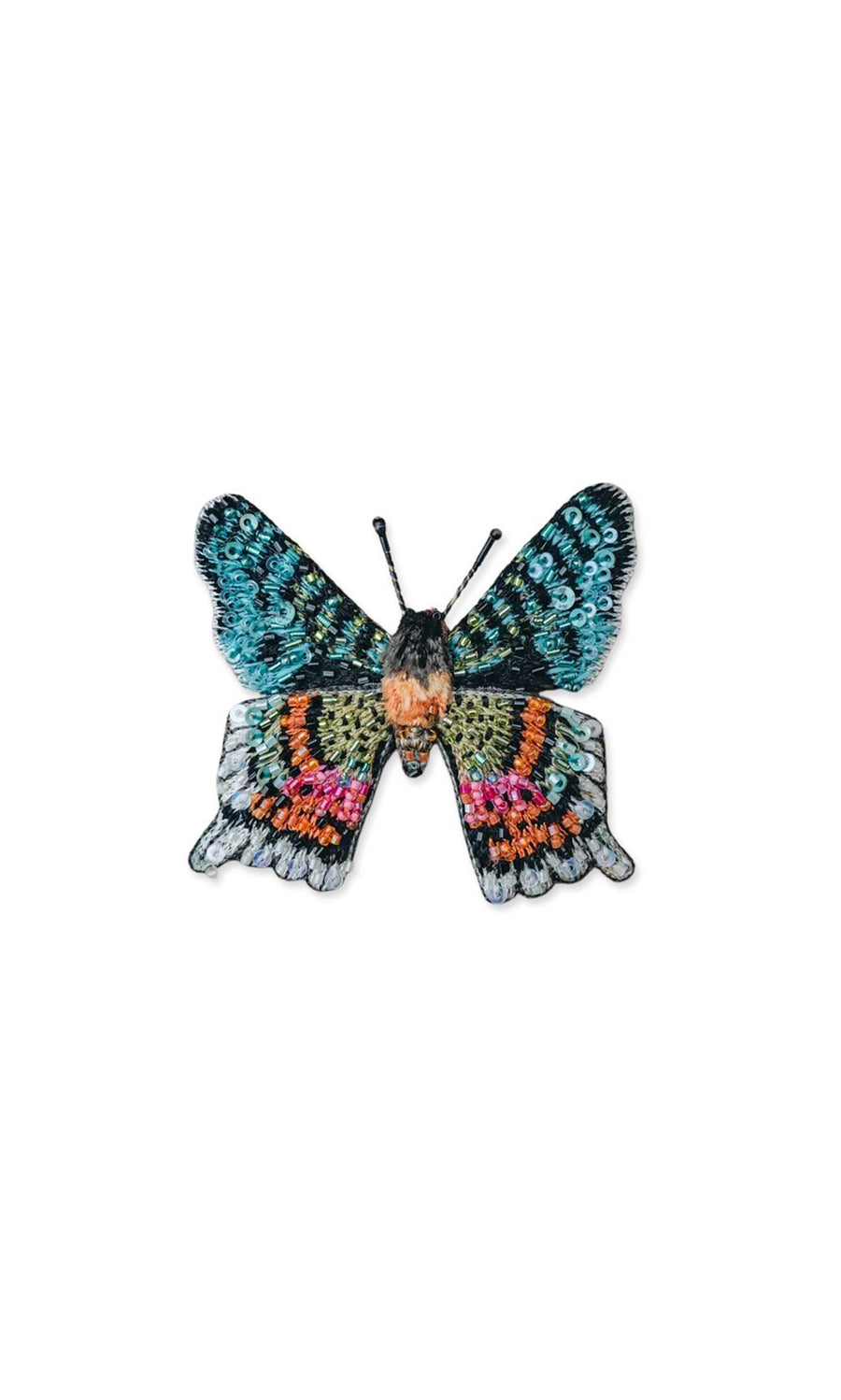 Plümo- The Sunset Moth Brooch is a hand-embroidered pin with blue, green, pink, orange, and black details on white.