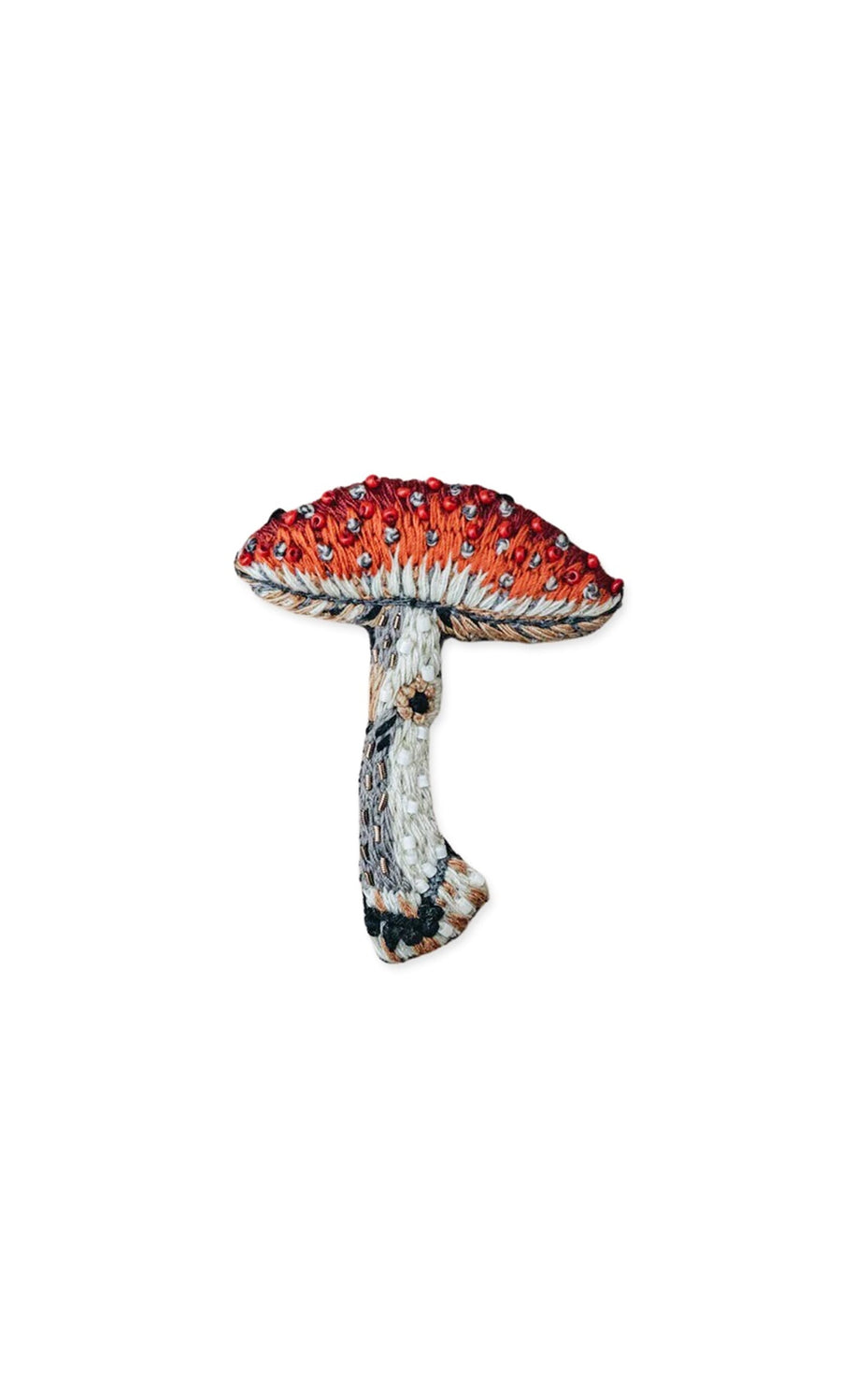 Plümo- Toadstool Brooch: Hand-embroidered red and white mushroom with a textured stem on a white background.