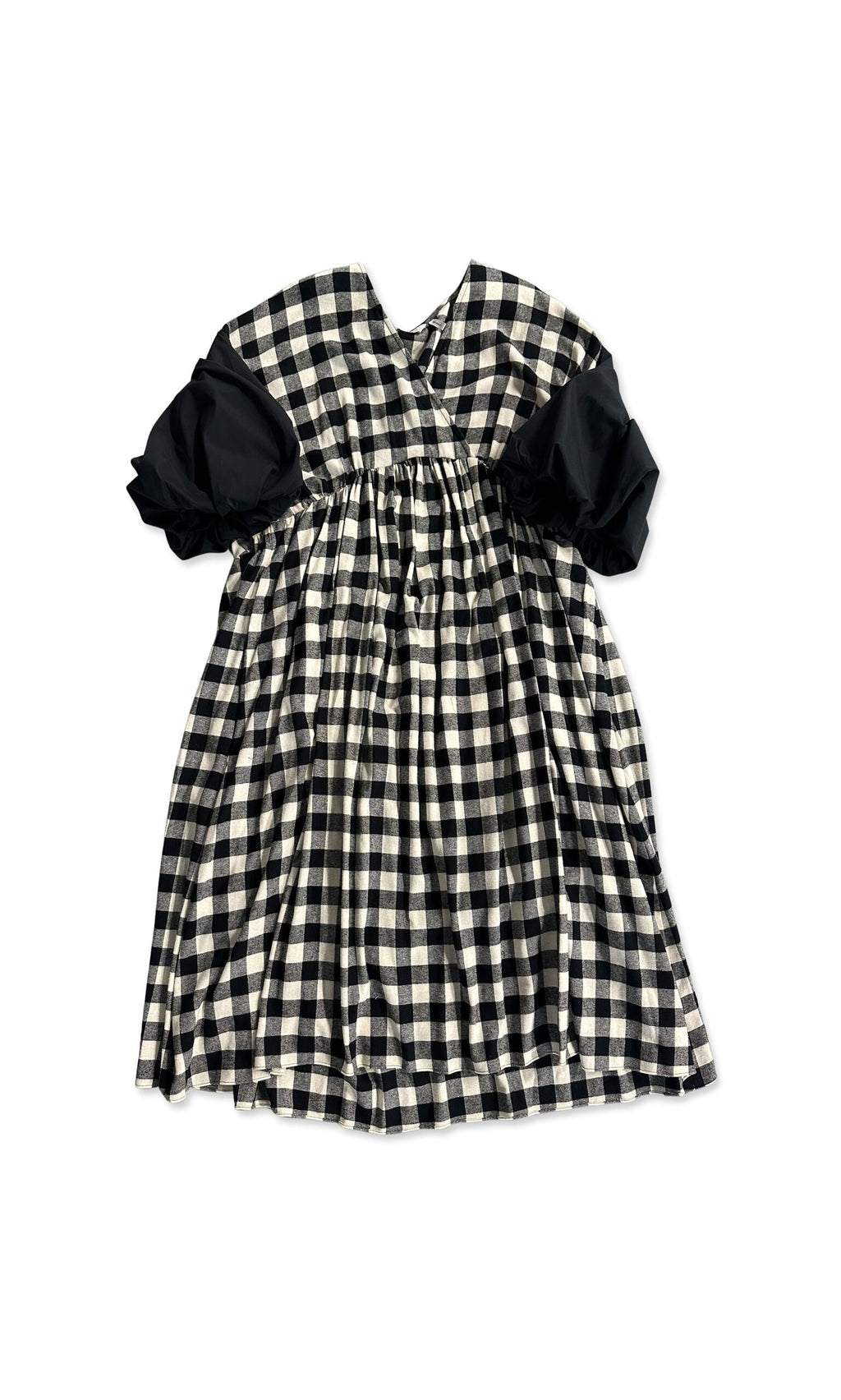 Plümo- Alya Dress: children's puff sleeve dress in black and white gingham, shown laid flat on a white background.