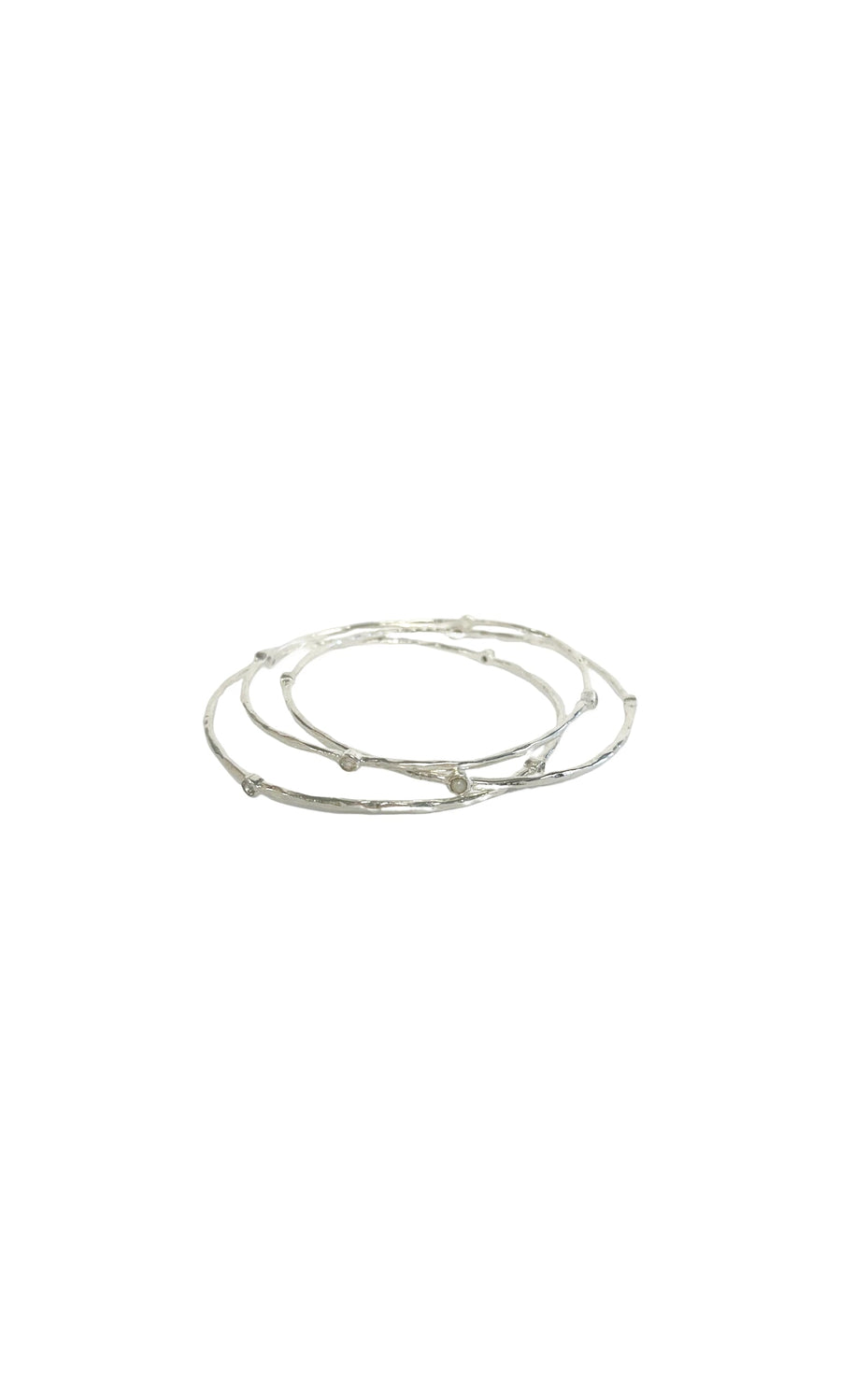 Plümo- Celeste Bangle Set: Three slim silver bangles with decorative knots, shown on a white background.