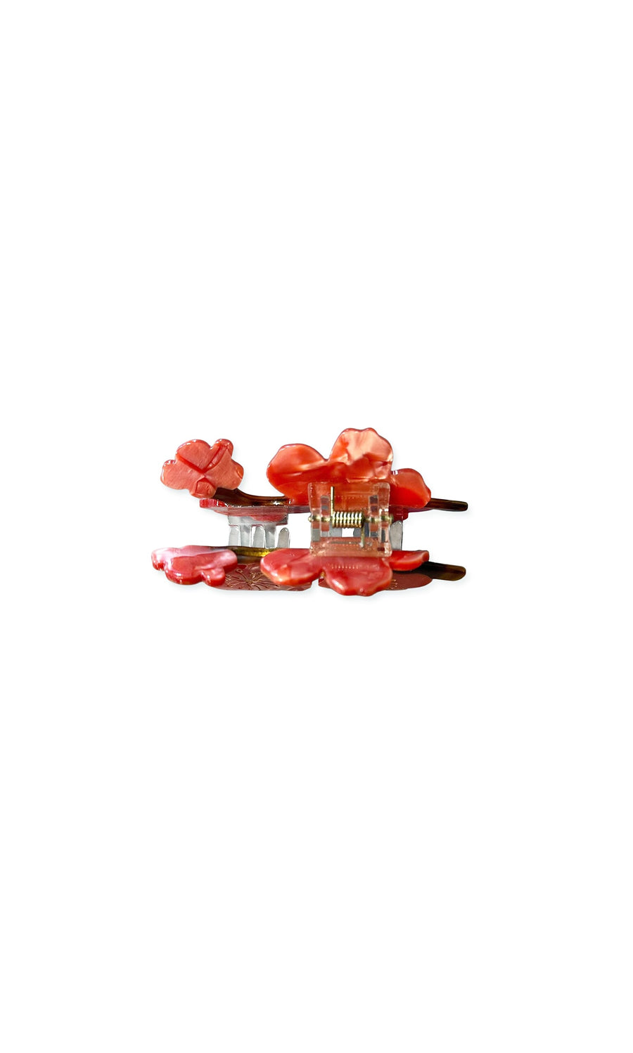Plümo- Cherry Blossom Clip - Coral: coral cellulose acetate hair claw with translucent petals, gold clasp, on white background.