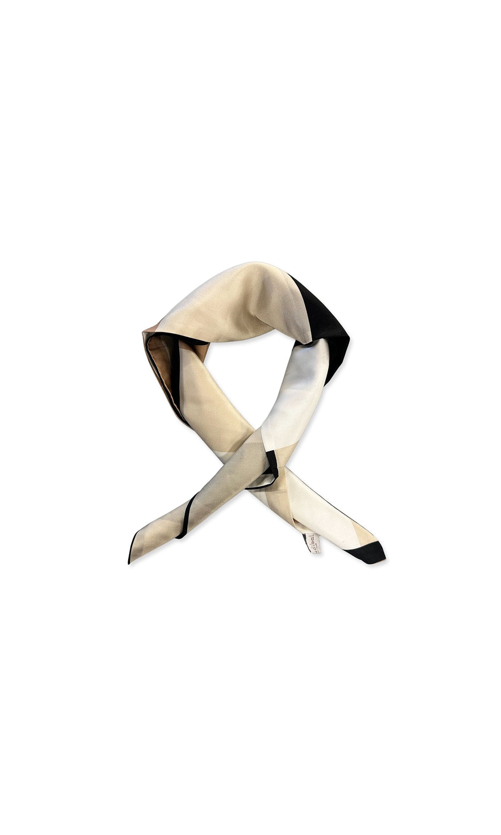 Plümo- The Dea Neck Scarf is cream-colored silk with a black geometric design, styled in a loose knot on white.