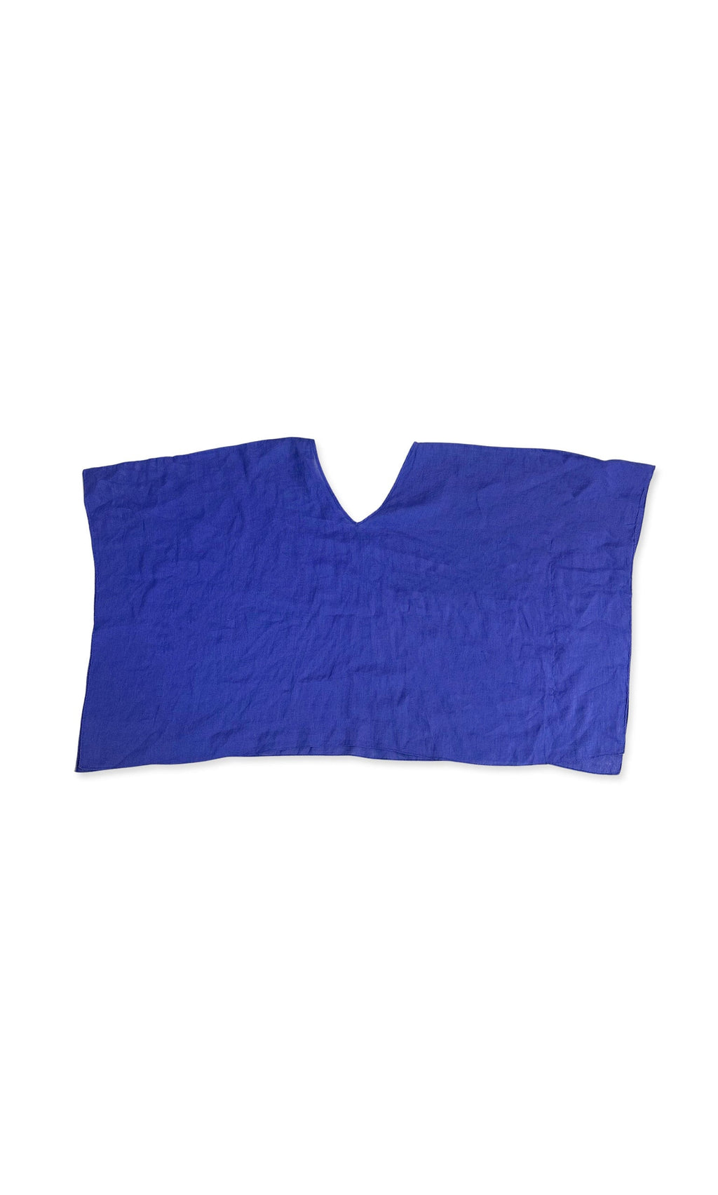 Plümo- The Drew Poncho, a plain blue linen piece with a V-neckline, is laid flat on a white background.