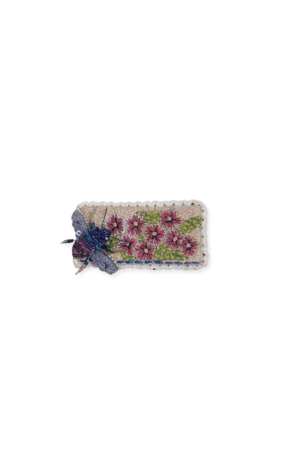 Plümo- Flower Bee Brooch: Rectangular, hand-embroidered with pink flowers, blue bee on left, and white crochet border.