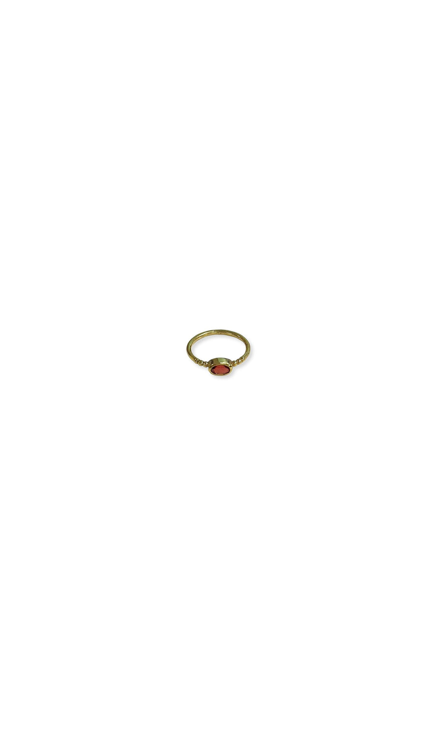 Plümo- The Garnet Ring is gold-plated with an oval garnet gemstone and a minimalist design on a plain white background.