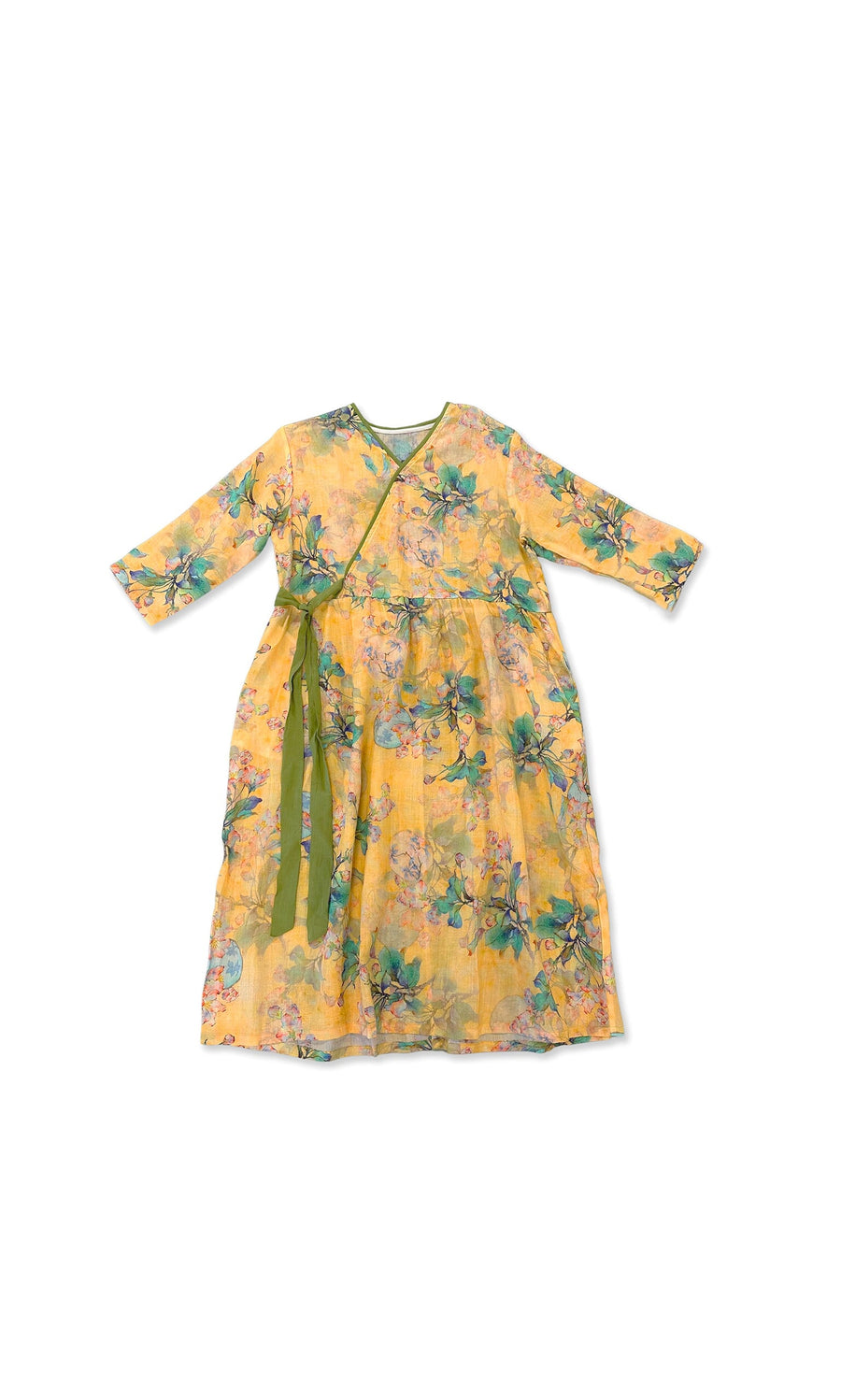 Plümo- The Hana Dress is a yellow floral wrap dress with long sleeves, a green ribbon waist, and vibrant flower prints.