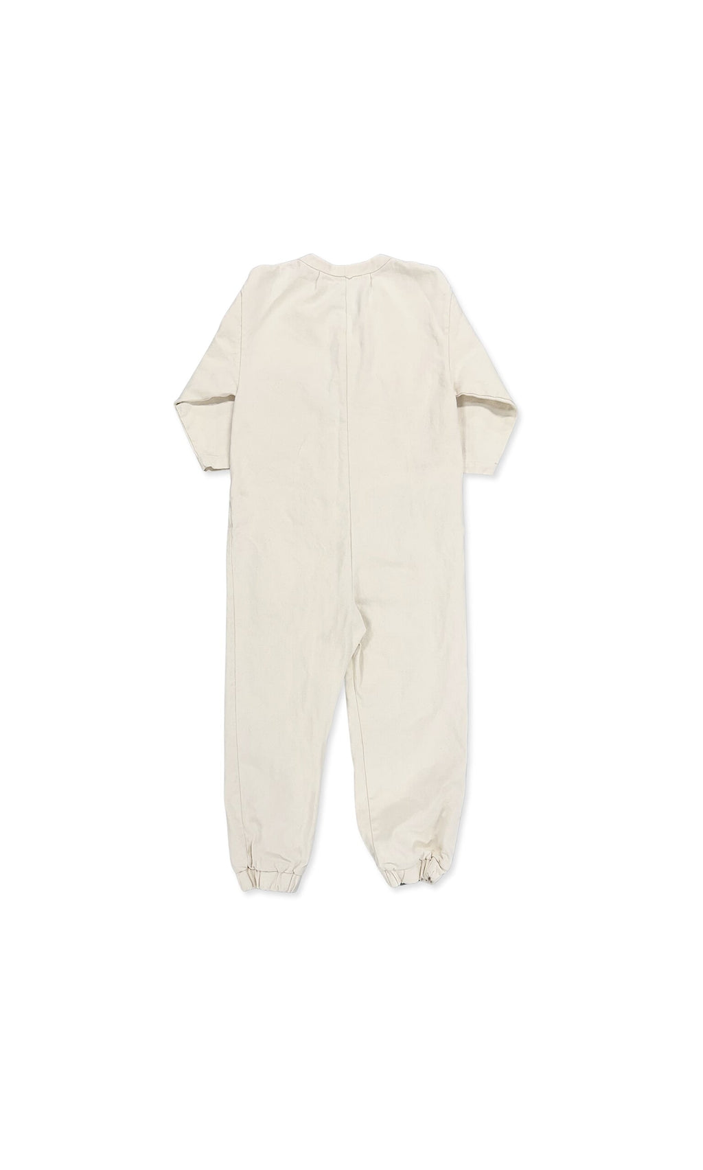 Plümo- Jodie Jumpsuit: Beige long-sleeve baby boiler suit with elasticized ankle cuffs, shown from the back.