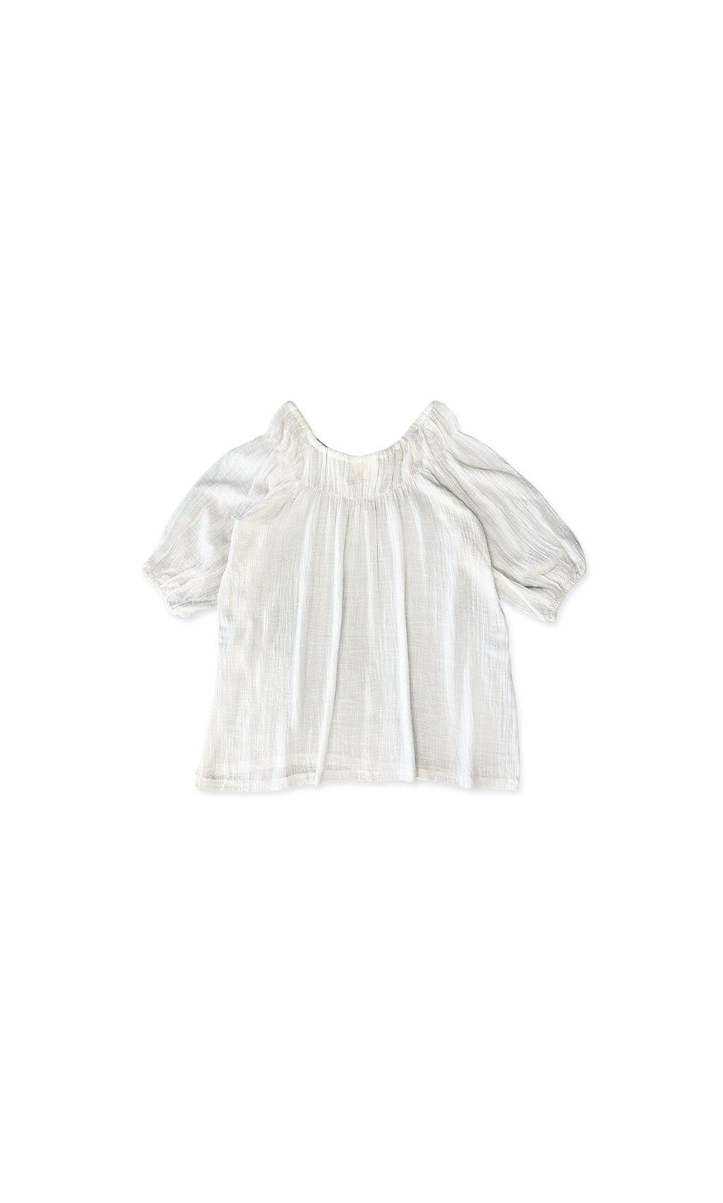 Plümo- The Judy Blouse is a white, short-sleeve flowy top with a relaxed fit and gathered neckline on a plain white background.