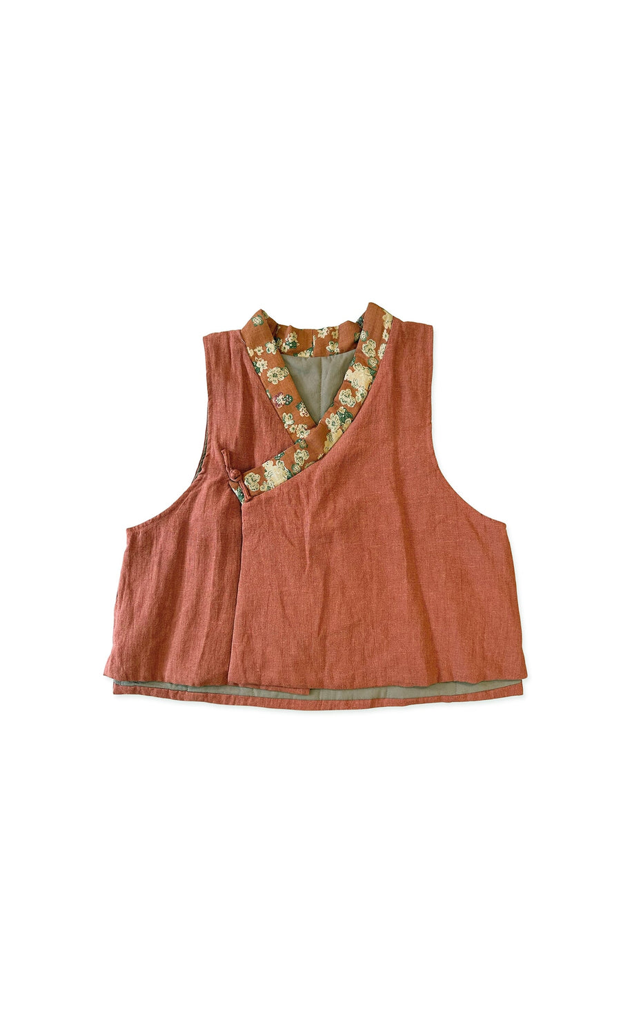 Plümo- The Ludo Waistcoat is a sleeveless reddish-brown quilted cotton vest with a floral-trimmed neckline on white.