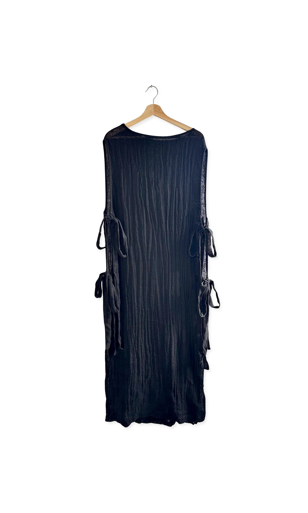 Plümo- The Lydia Linen Tabbard is a long, sleeveless black piece with side ties—perfect for effortless layering.