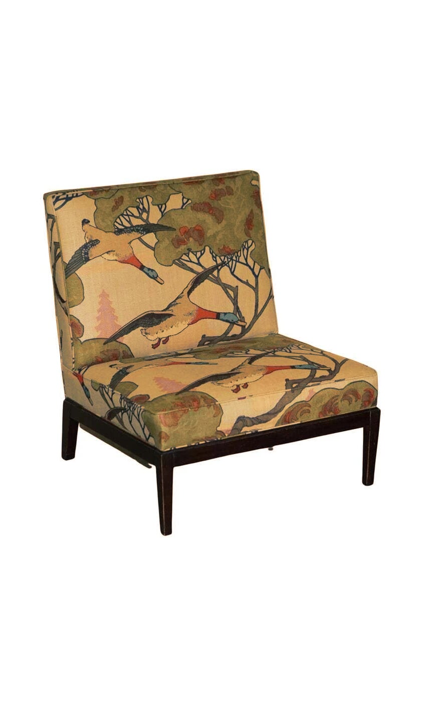 Plümo- Armless chair with dark wood legs, upholstered in Mulberry's 'Flying Ducks' linen fabric with a colorful tree pattern.