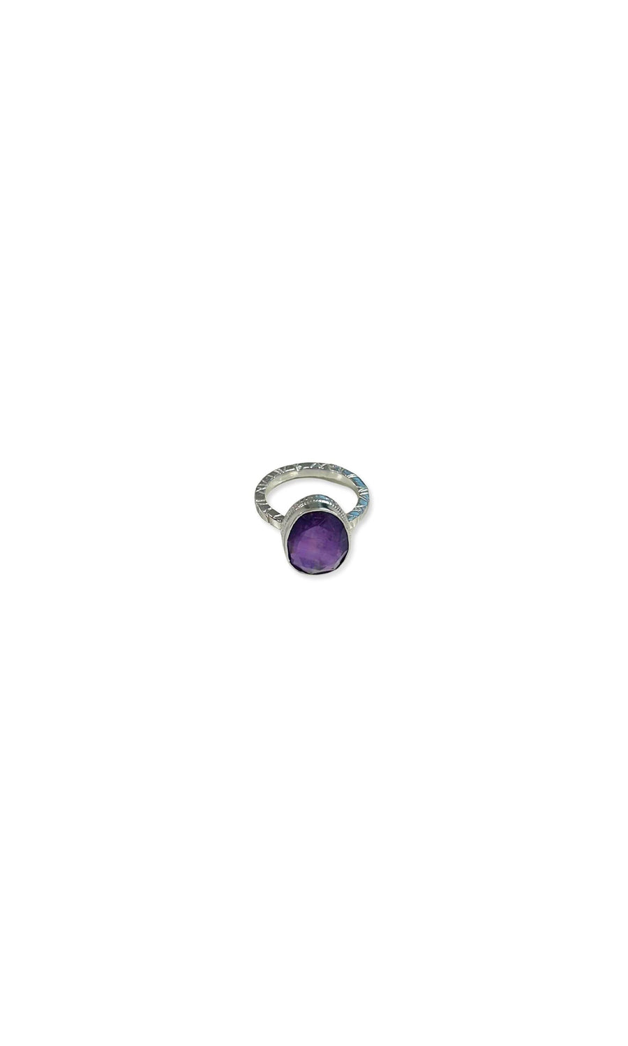 Plümo- Amethyst Ring: Sterling silver band with textured detail and a round purple crystal, shown on a white background.