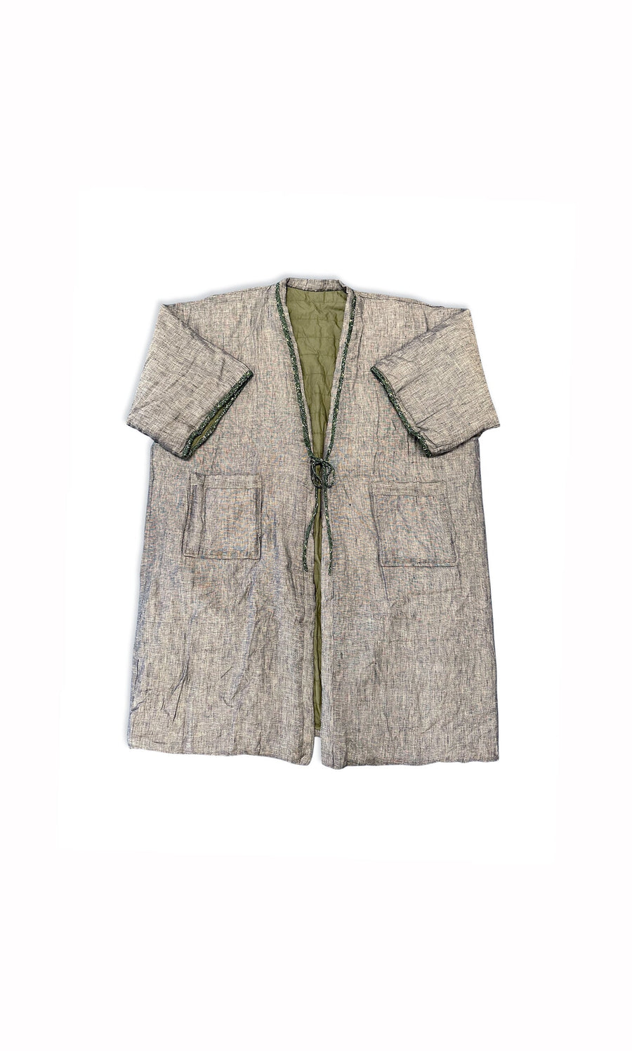 Plümo- The Akira Padded Coat is a gray, loose-fit, knee-length jacket with big front pockets and a green interior lining.