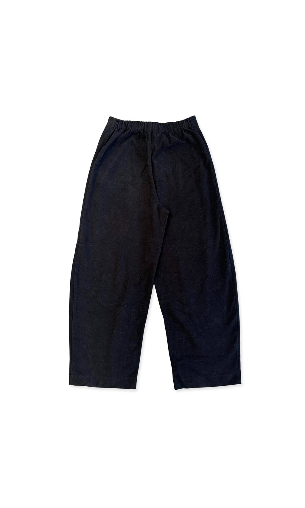 Plümo- Shilo Pants: Black, loose-fit cotton barrel pants with elastic waistband, shown flat on white background.