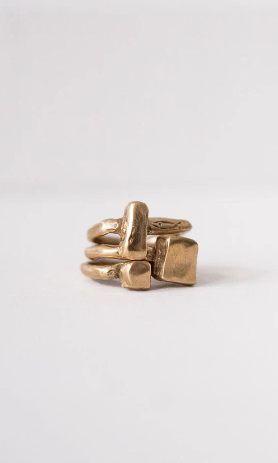 Plümo- The Stack Ring features three unique gold bands, each crafted with lost wax casting, shown on a plain background.