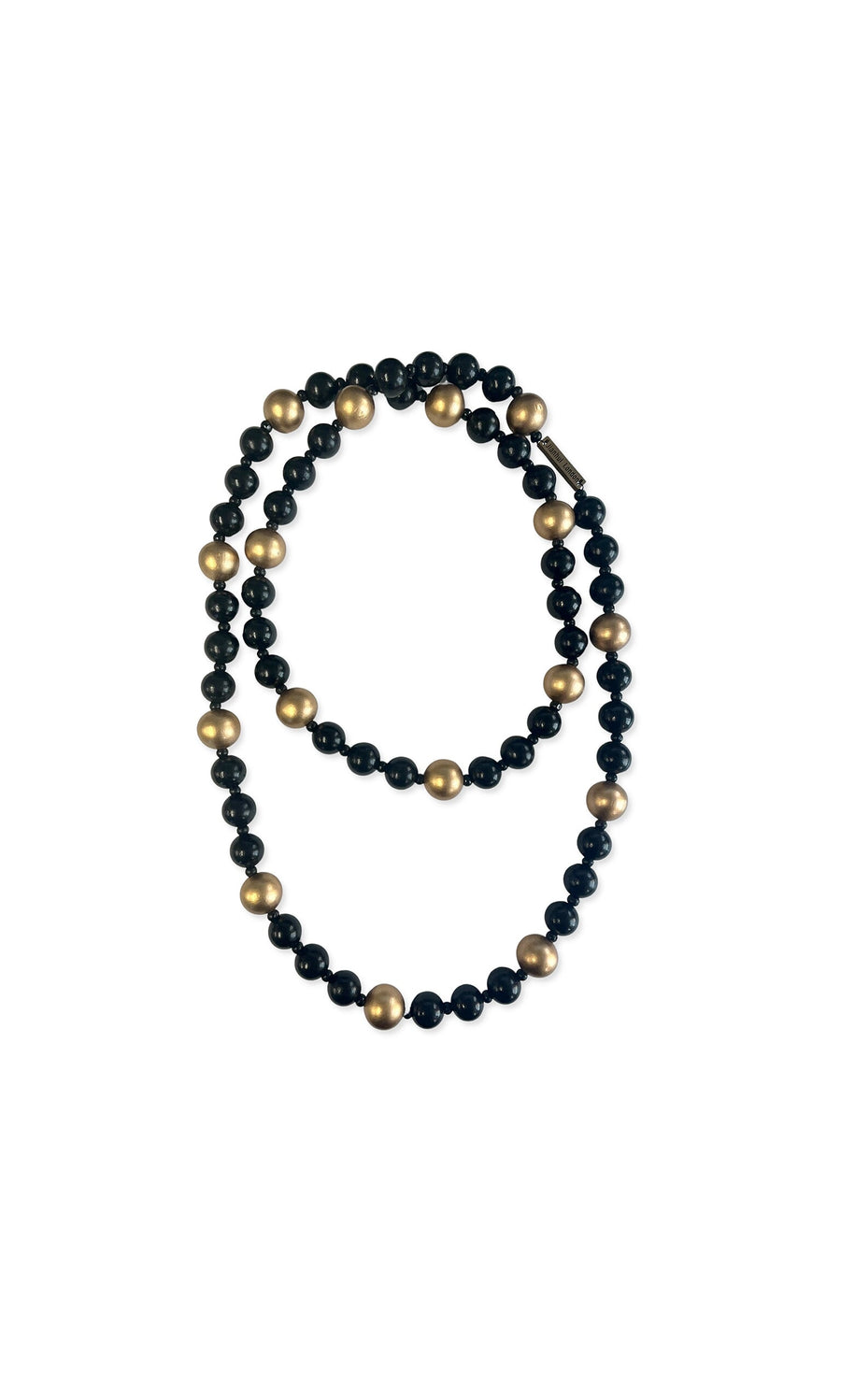 Plümo- The Suna Necklace features black wooden beads with gold accents, beautifully arranged in a loop.