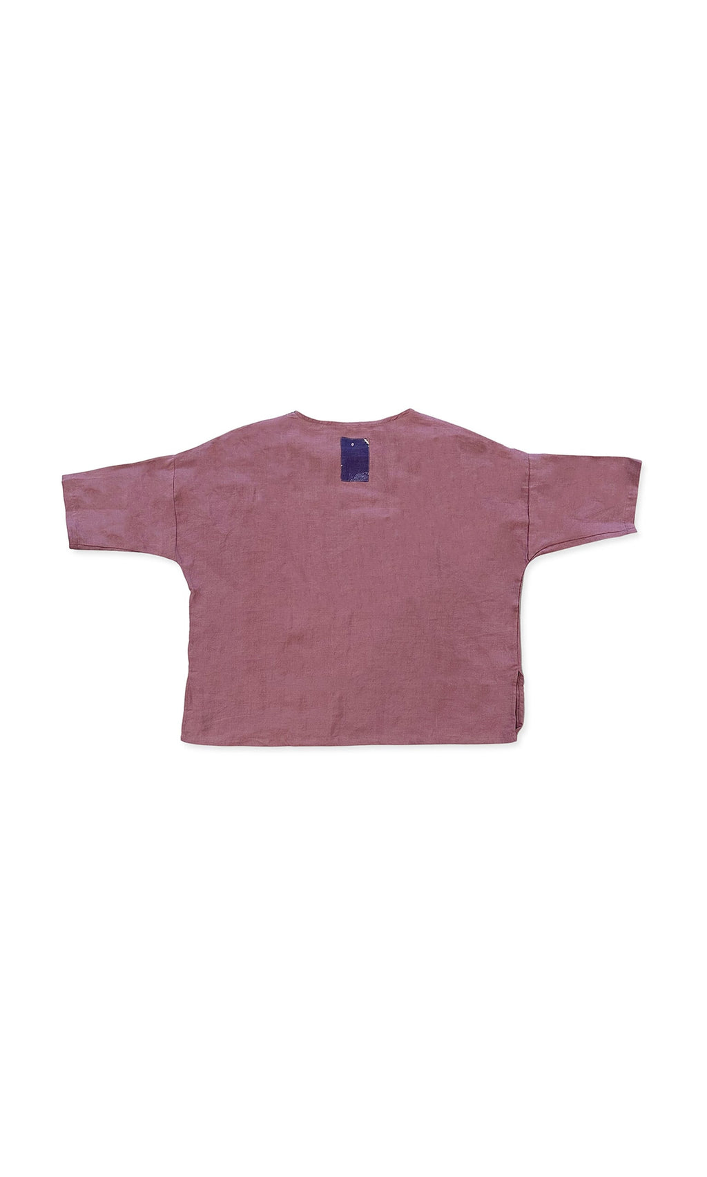 Plümo- The Thora Top, a boxy-fit mauve linen long-sleeve shirt, lays flat with a blue tag on the back neck.