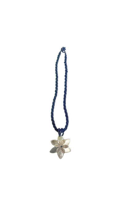 Plümo- The Valeria Necklace is a beaded dark blue piece with a shell flower pendant, shown on a white background.
